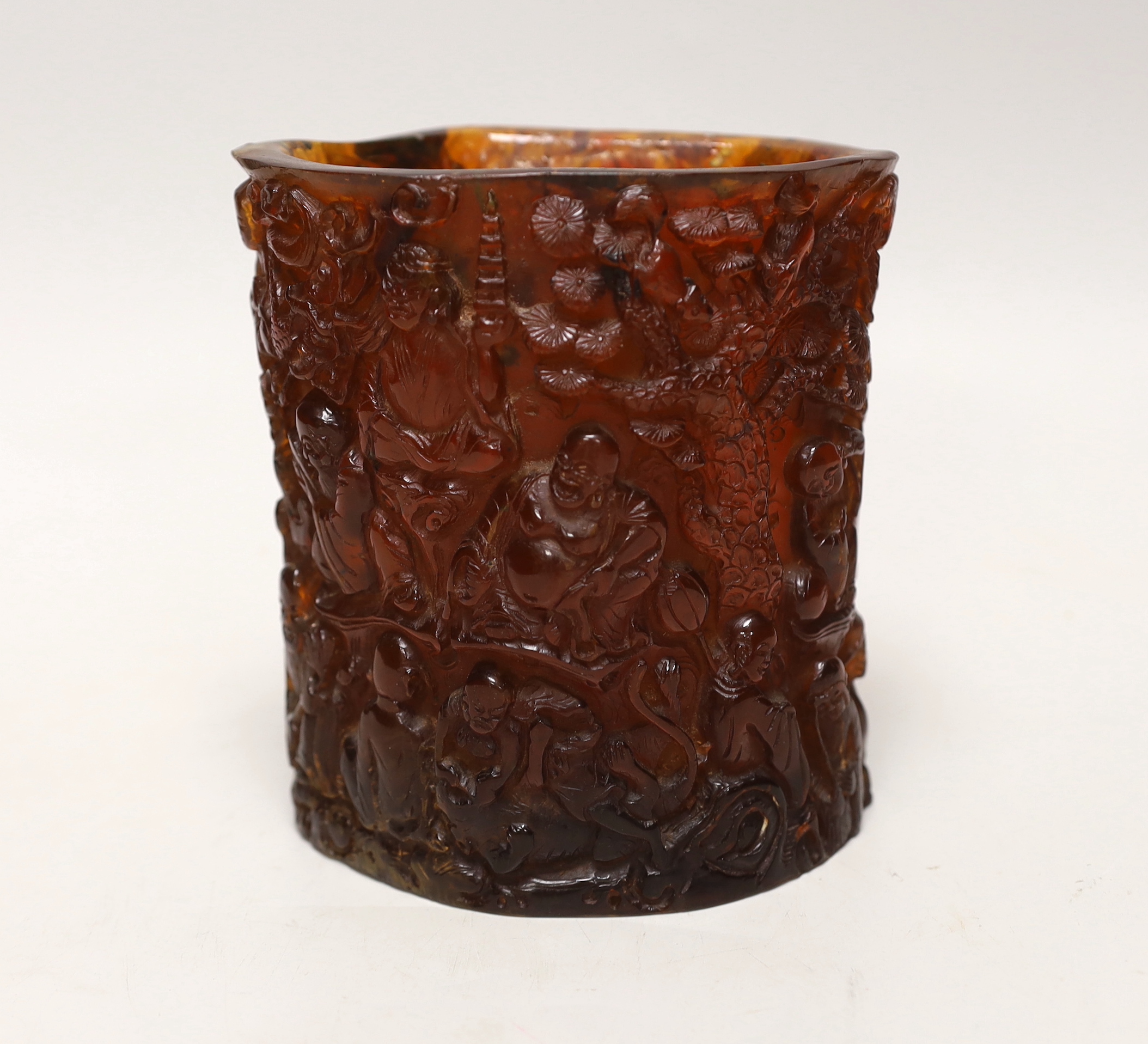 A Chinese amber coloured moulded plastic brush pot, 13.5cm